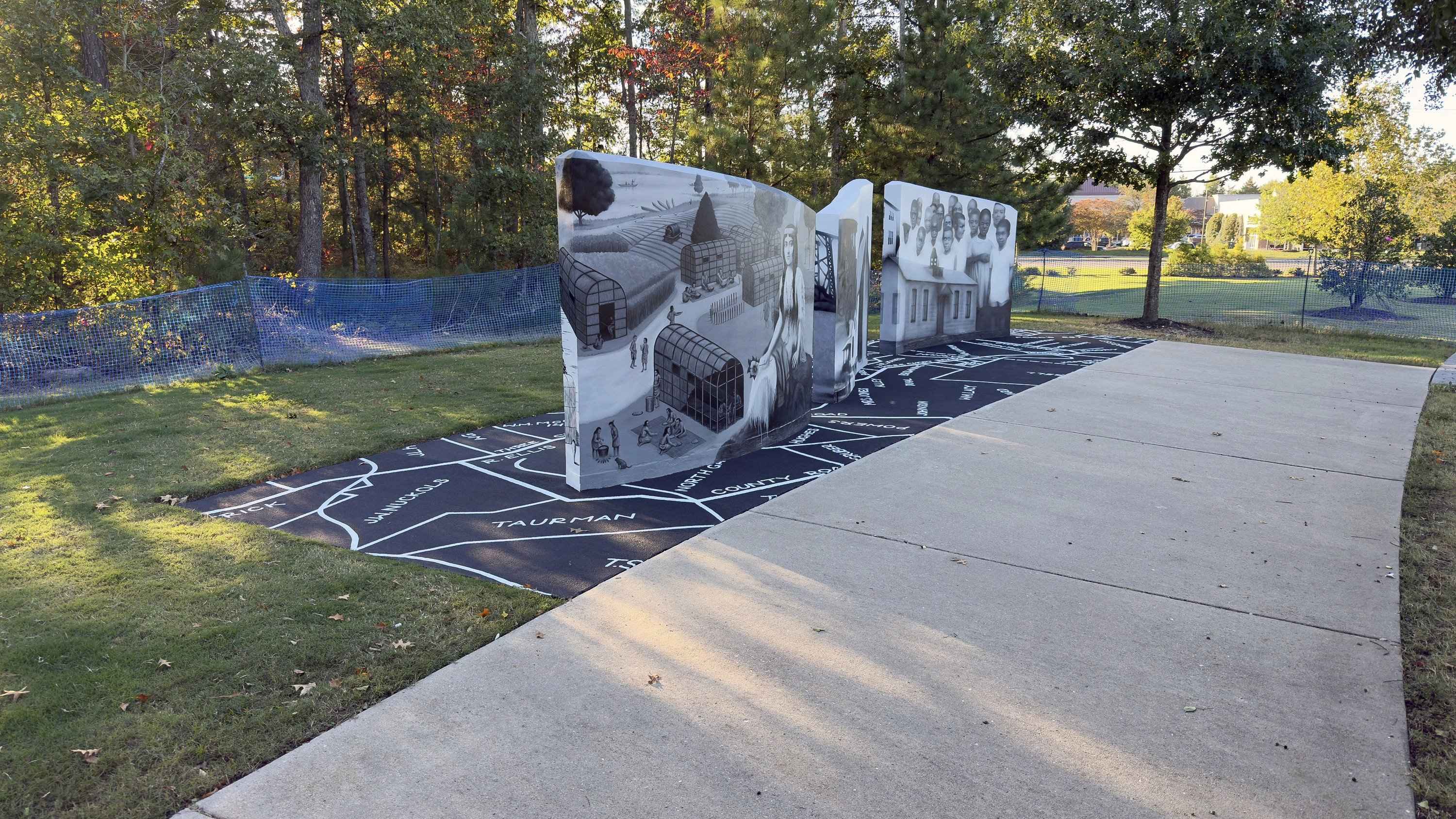 The finished walls and the painted map from the park path, white property lines and names on the black slab