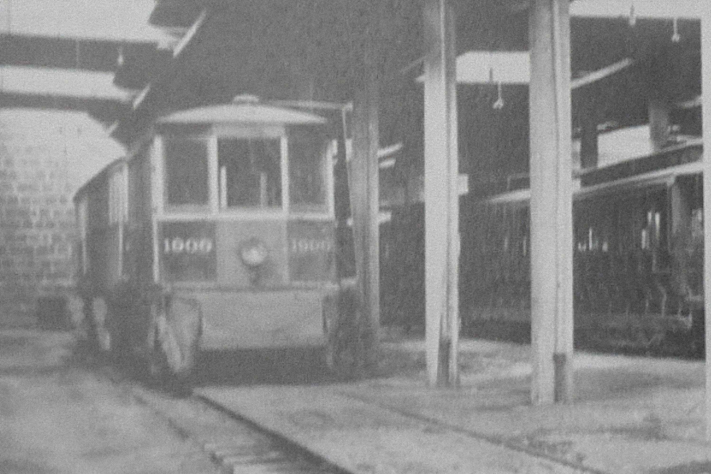The archival photograph of a streetcar inside the barn, painted on the left wall