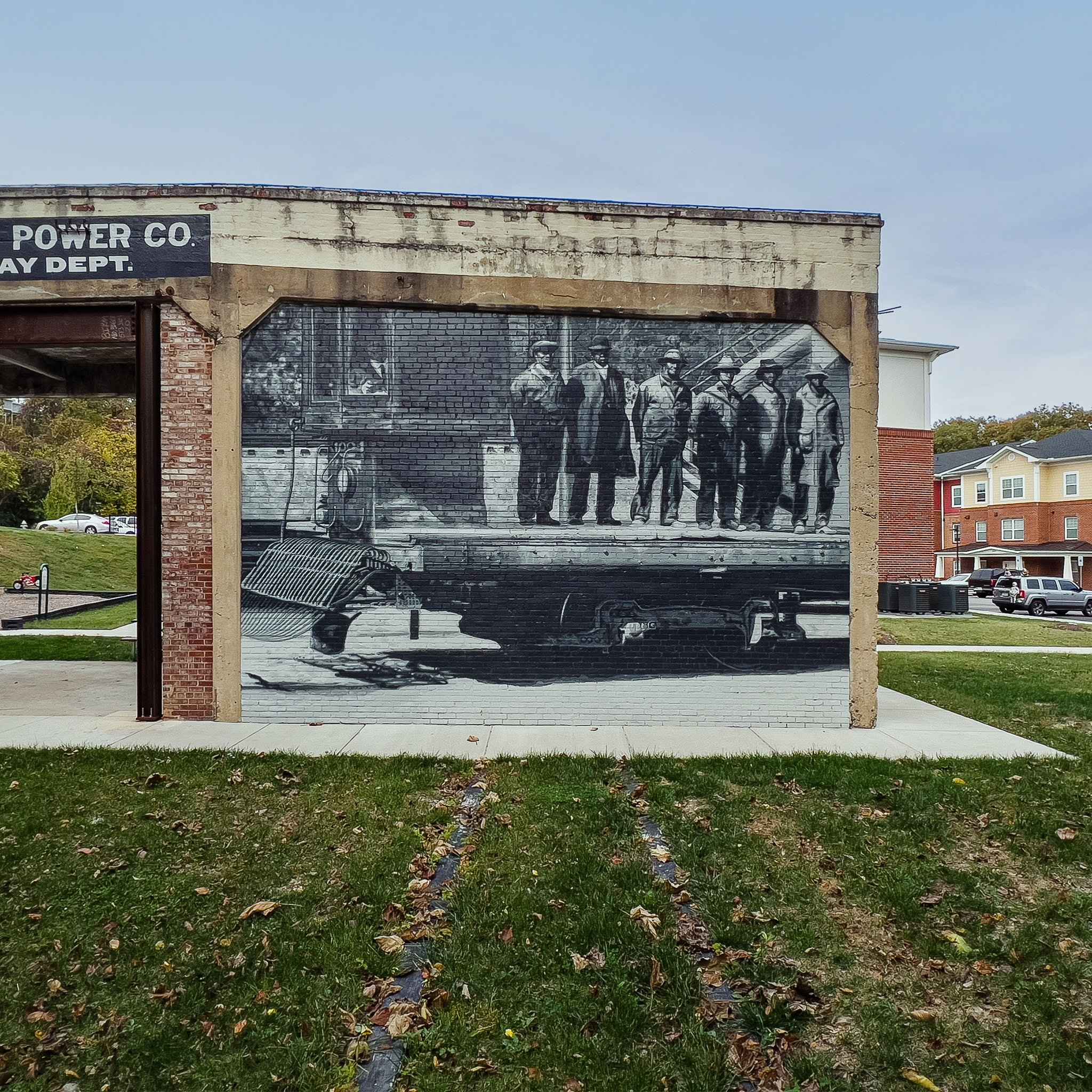 The long wall square on: the crew standing on the flatcar, painted brick by brick