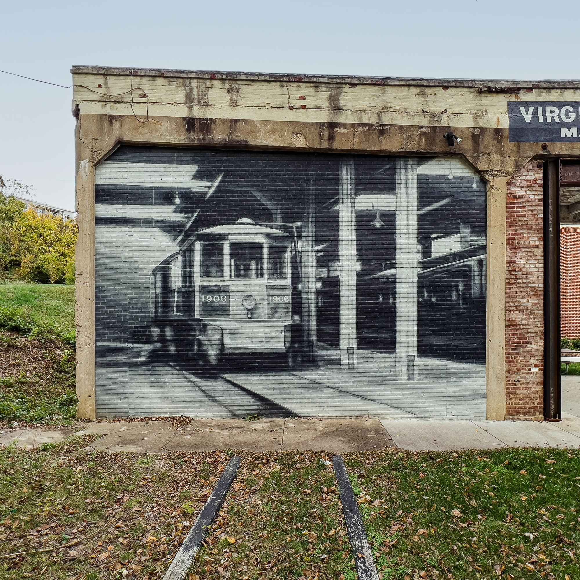 The streetcar bay square on: car 1906 inside the barn, painted on the preserved wall
